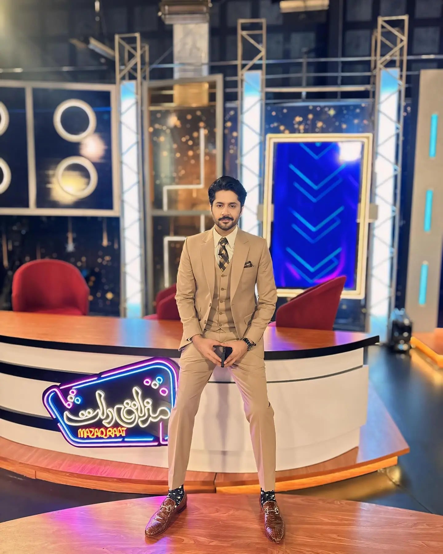 A man wearing a classic camel beige three-piece suit with matching vest and trousers by ahsan tariq paired with patterned brown shoes