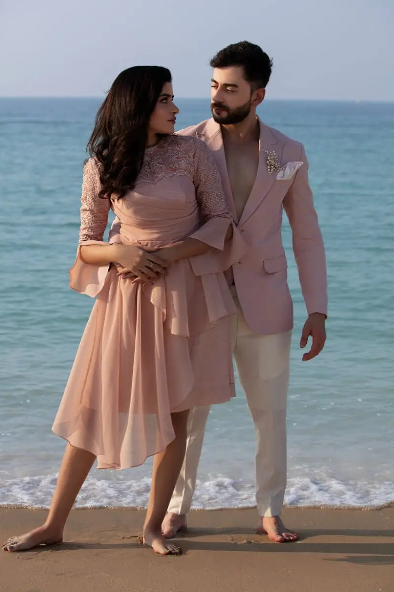 A soft pink lace-trimmed midi dress with flared sleeves and flowing skirt from ahsan tariq dusk duo collection