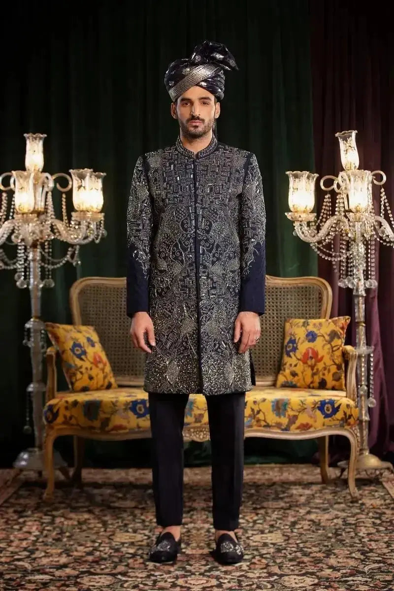 The Mastaan sherwani in dark navy raw silk features silver embroidered geometric patterns for formal wear