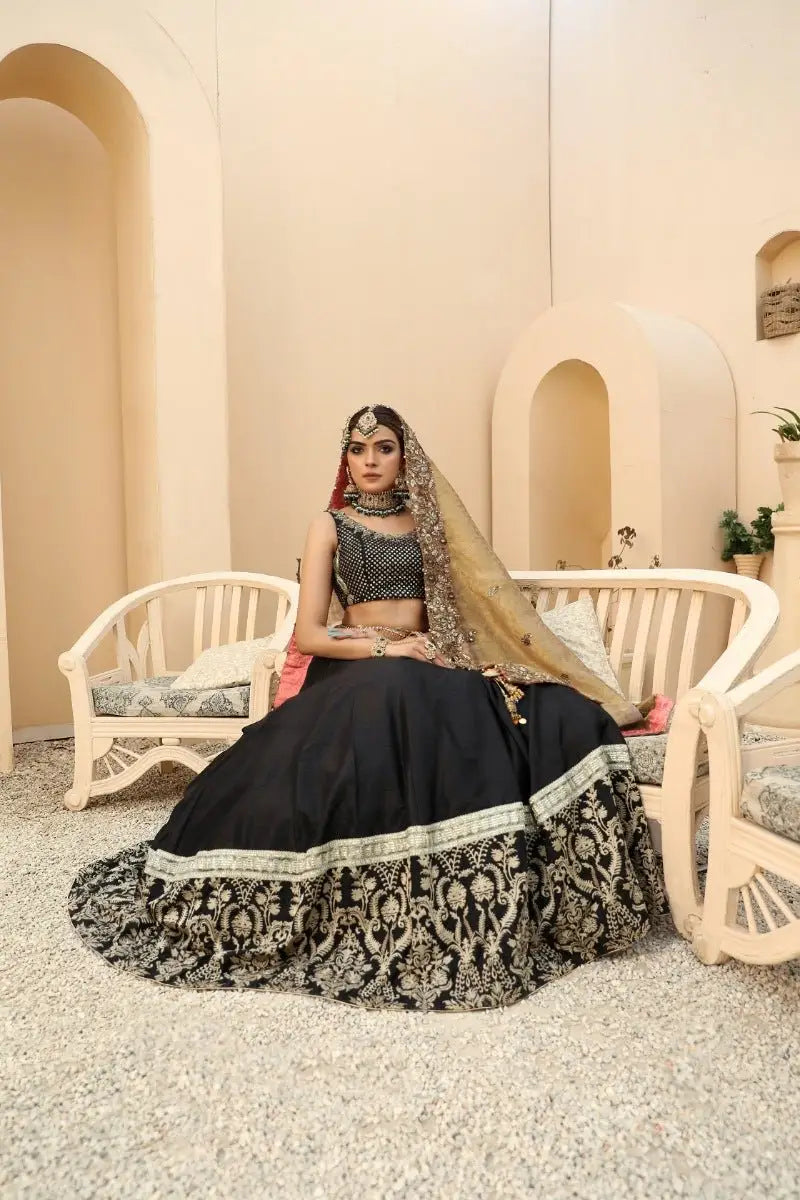 Black lehenga nayab with intricate gold embroidery and matching embellished blouse by ahsan tariq prince coat collection