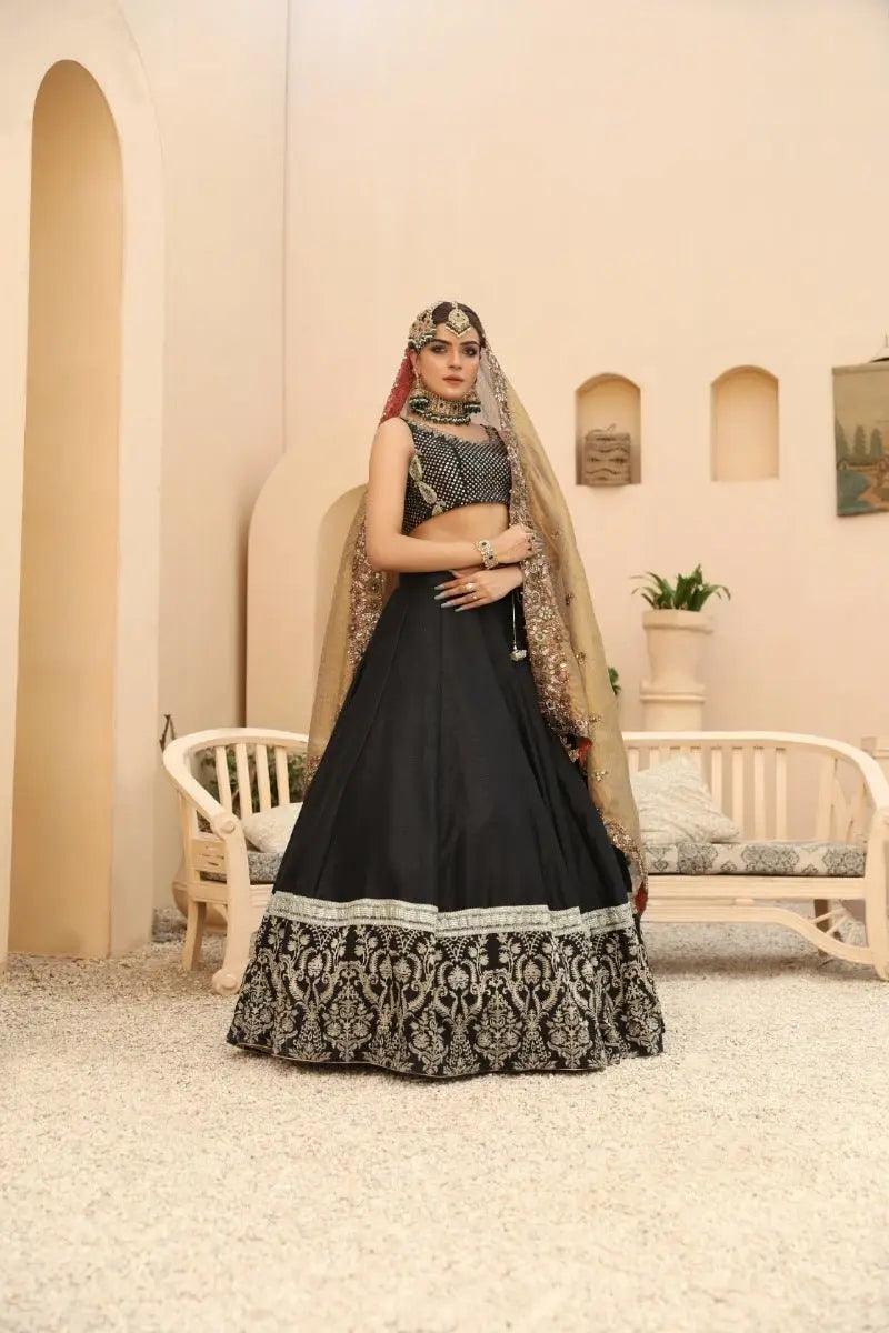 Black lehenga with intricate silver embroidery and matching embellished blouse by ahsan tariq prince coat collection nayab