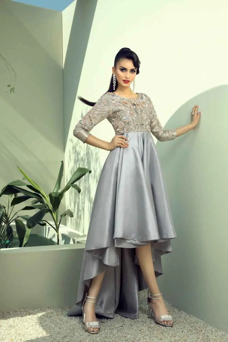 Quicksilver gown by ahsan tariq features a mesmerizing blend of silver-gray high-low lace with three-quarter sleeves and beaded heels