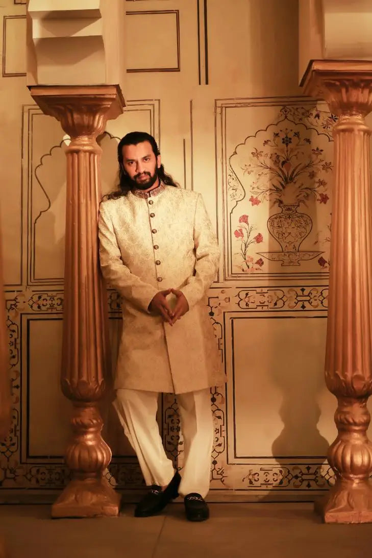 Ranjha cream-colored traditional indian sherwani with intricate embroidery gold-toned buttons and high collar