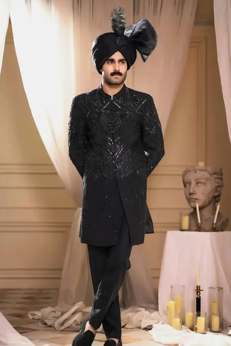 Black raw silk sherwani tajdar with intricate silver threadwork and matching turban featuring bow and feather