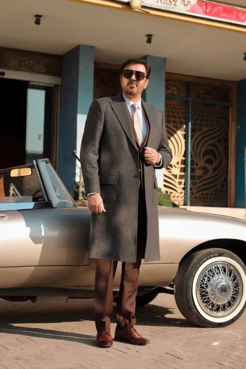 A sleek silver convertible car with chrome wire wheels and classic design in waheed murad virsa-e-sitaaran edit 26