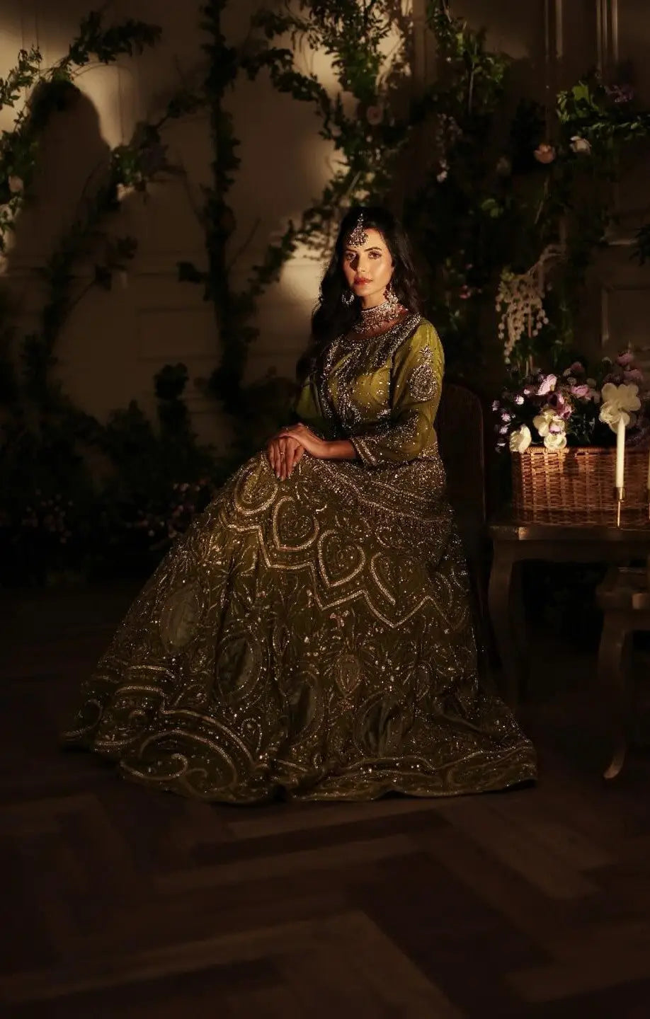 Zebaish olive-green lehenga with intricate silver embroidery and sequins by Ahsan Tariq featuring antique gold accents