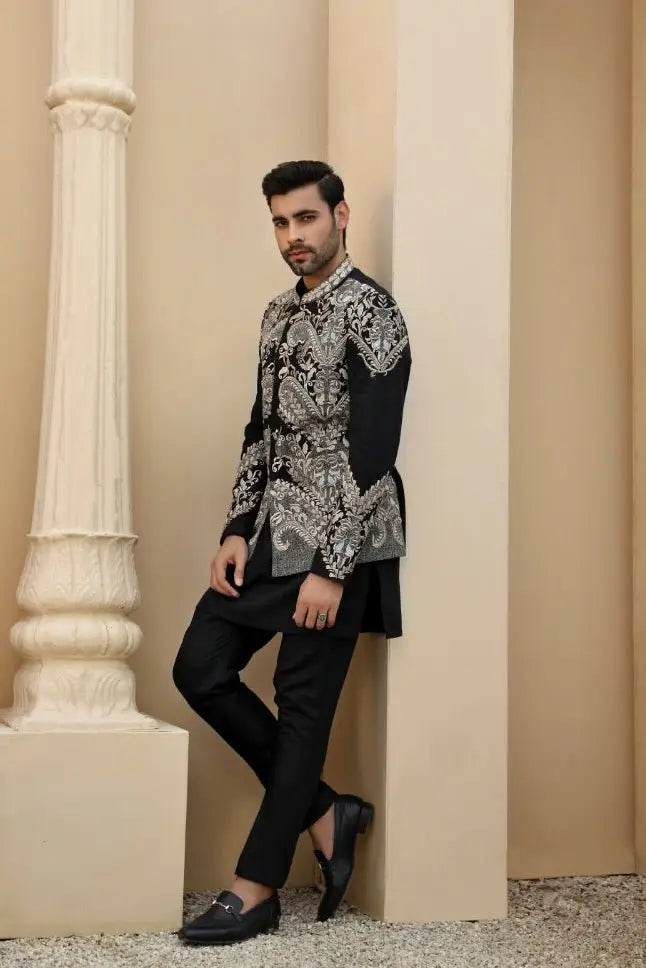 Black embroidered sherwani from raqeeb se collection with intricate silver paisley patterns by ahsan tariq prince coat