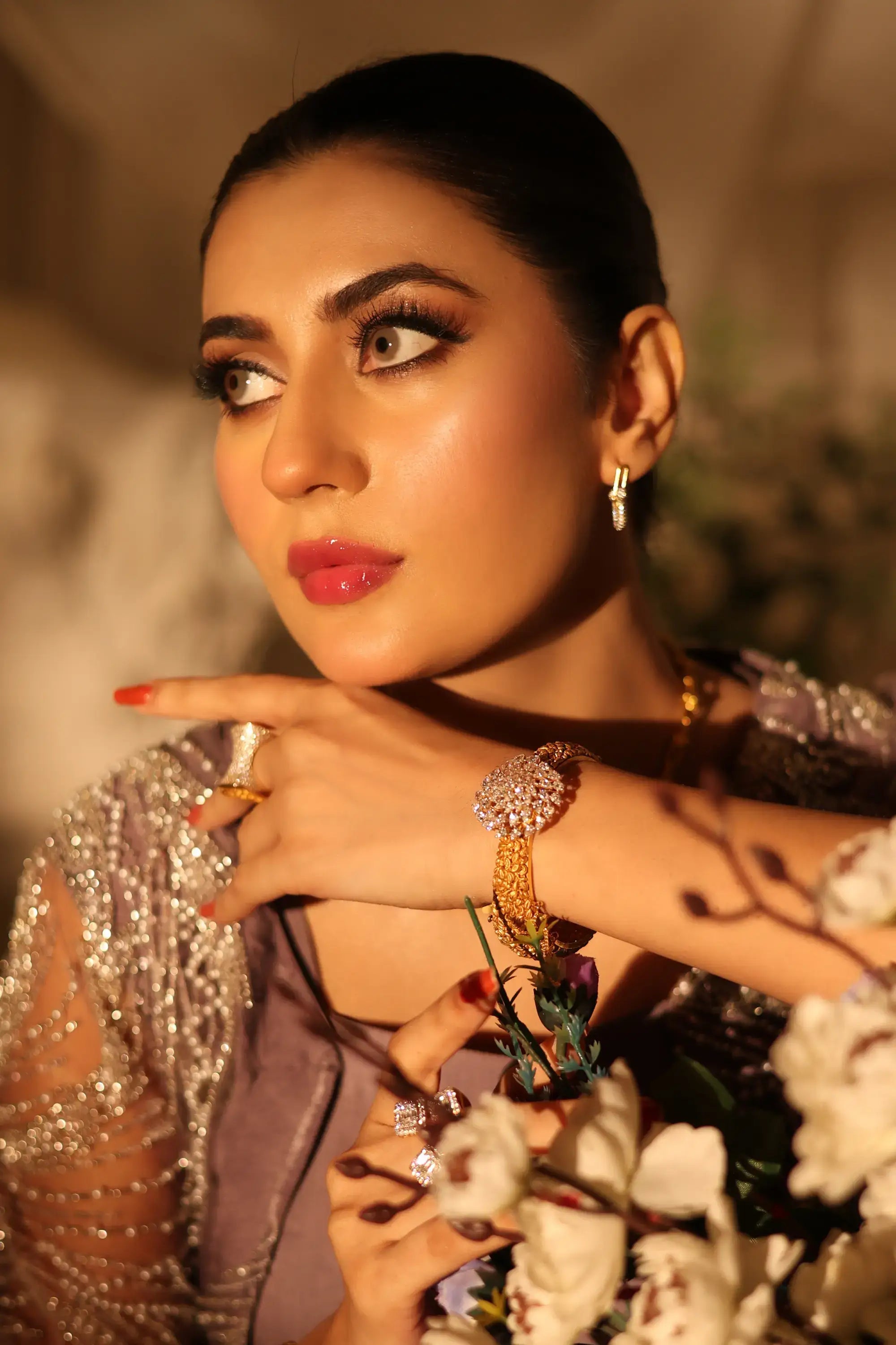 Gold-toned bracelet with ornate sparkling floral centerpiece and intricate beads from amara drape ensemble