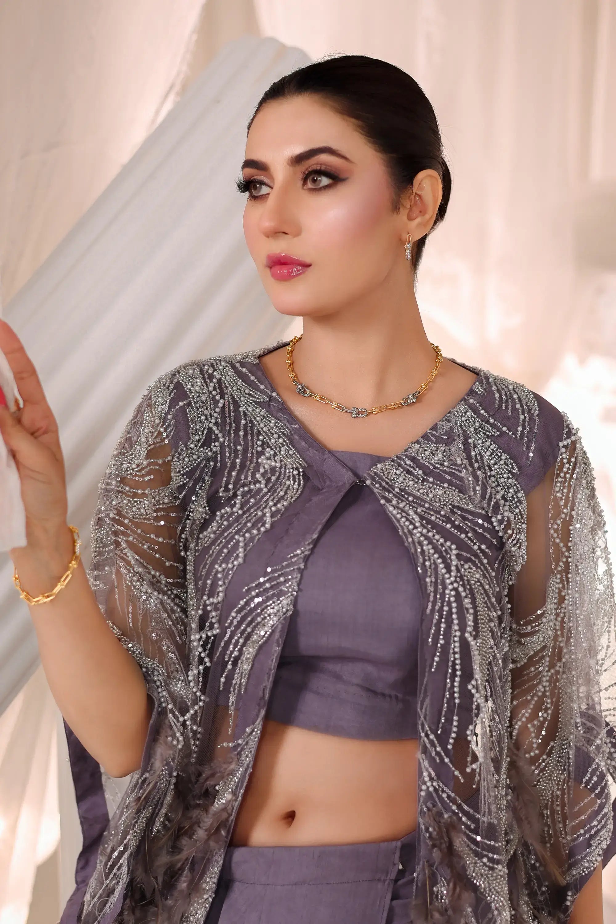 Shimmering silver beaded sheer overlay jacket with flowing design over purple crop top in amara drape ensemble