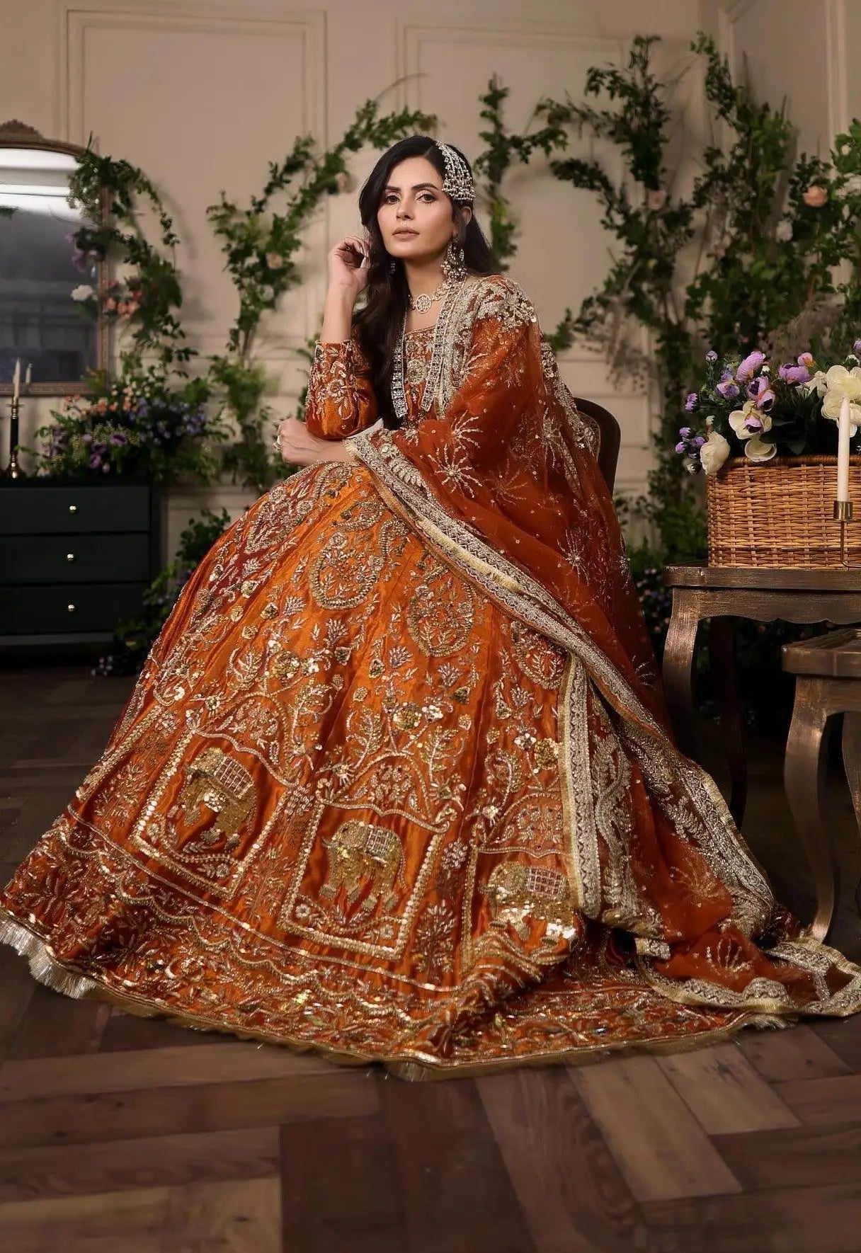 Ambar breathtaking lehnga choli in vibrant amber rust hue with intricate gold silver threadwork and elephant motifs