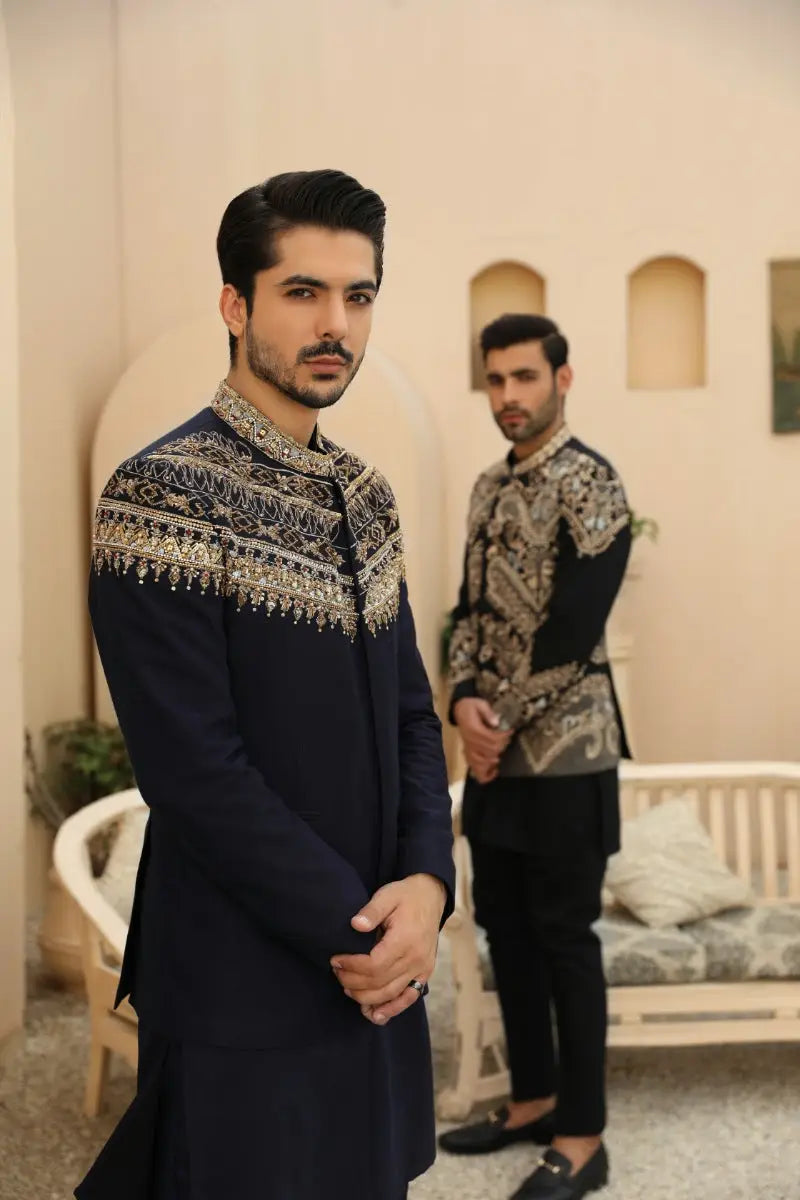 Navy blue embroidered sherwani azraq with intricate gold thread detailing on collar and shoulders prince coat silhouette from raqeeb se collection