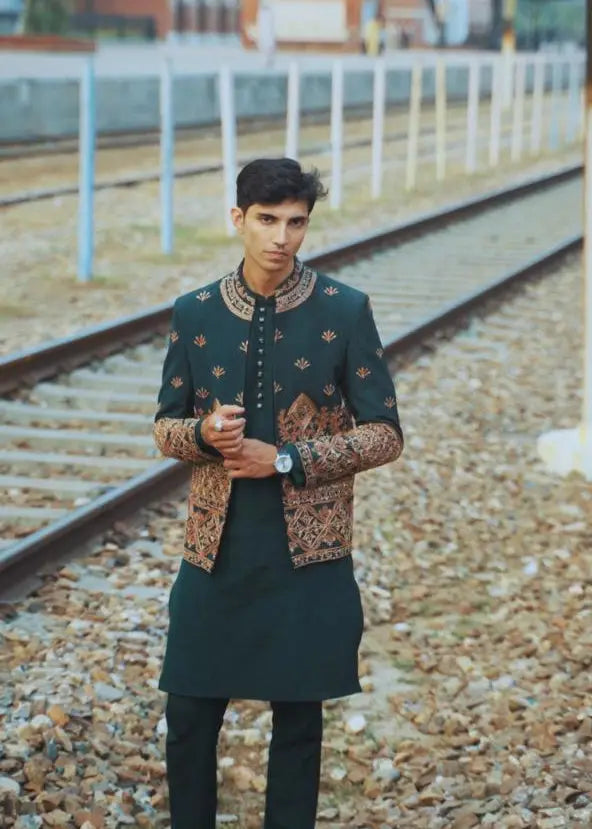 Dark green embroidered sherwani bagh-e-zar with intricate gold and brown floral patterns for formal occasions