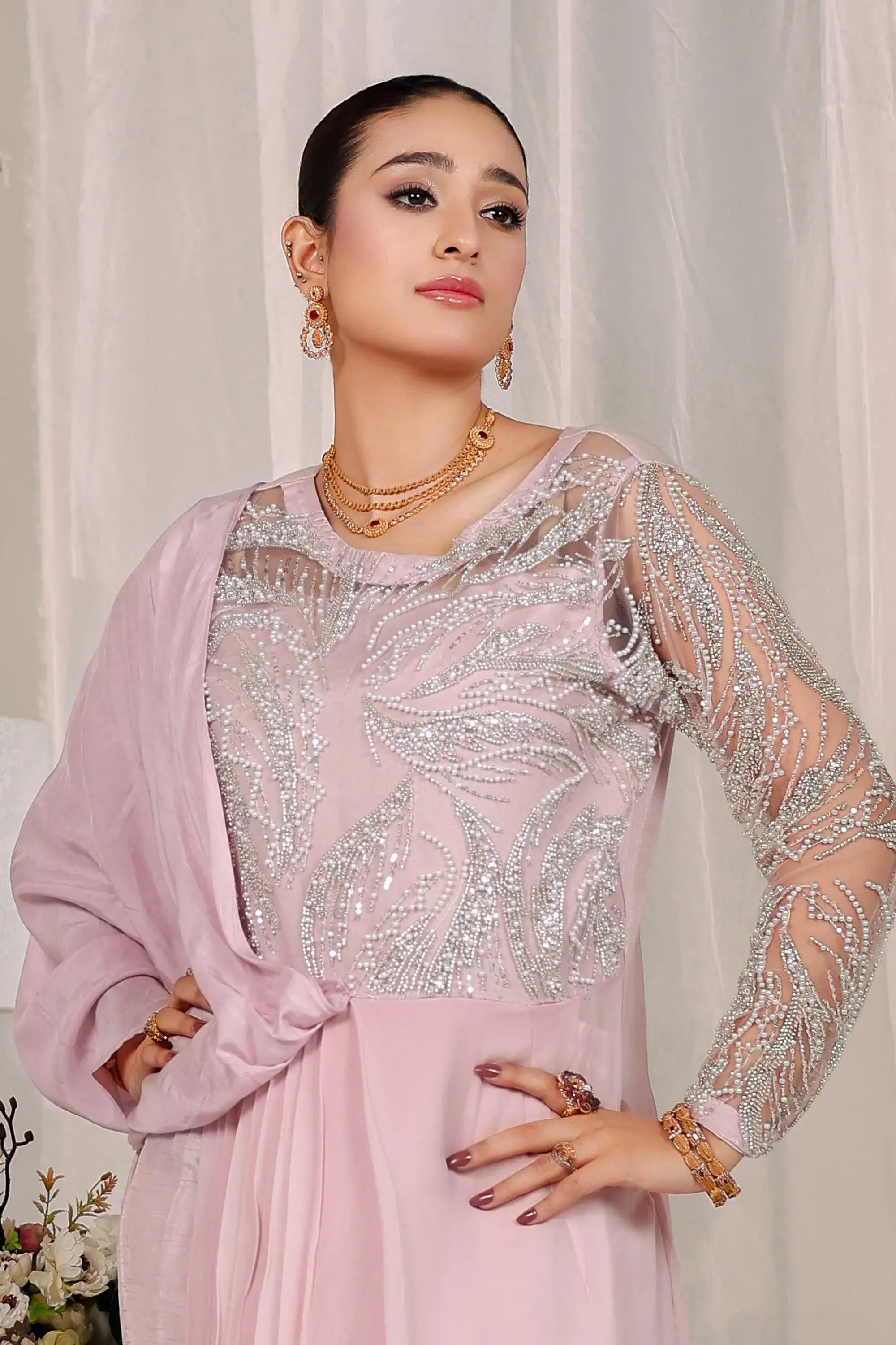 A blush opulence delicate pink gown by ahsan tariq with sheer silver beaded long sleeves and embroidered bodice in soft blush pink