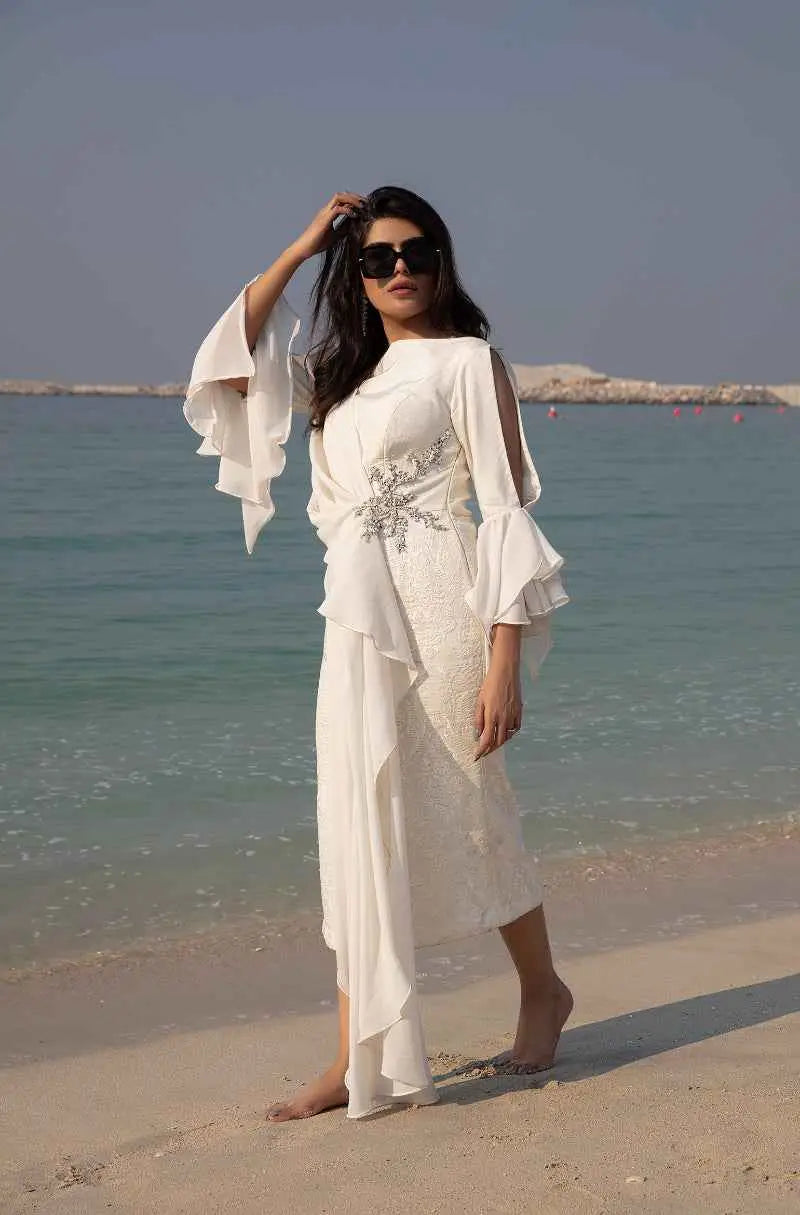 Elegant white lace celestial drape dress with flared bell sleeves and silver waist embellishment high fashion statement piece