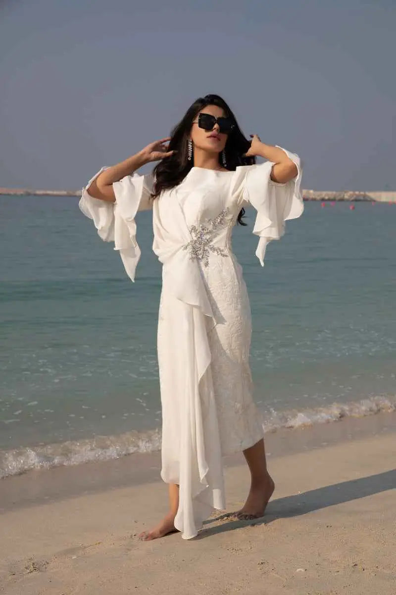 White flowing dress celestial drape with delicate silver embellishments and flared sleeves high-fashion statement piece