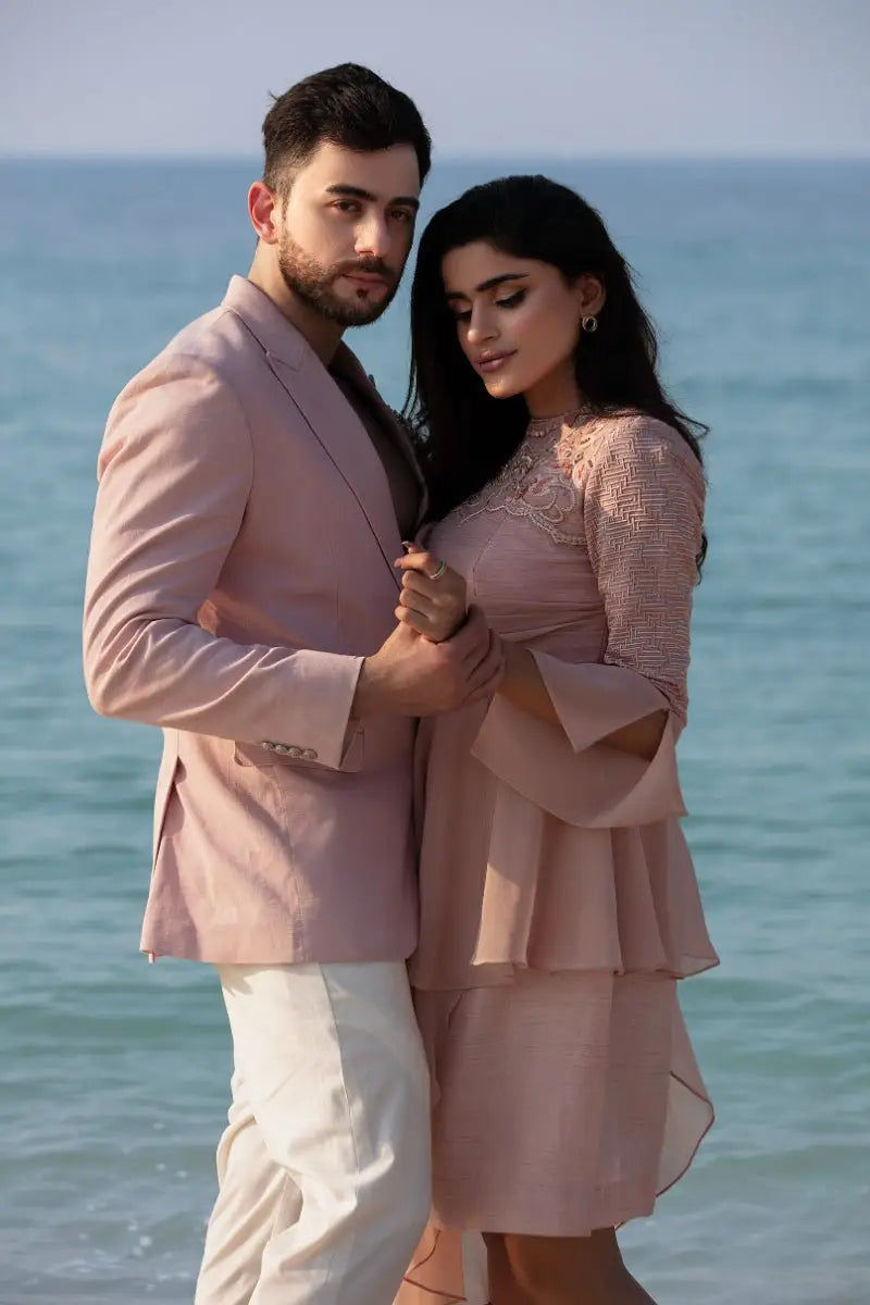 A soft pink dusk duo dress by ahsan tariq with lace trim tiered ruffles and bell sleeves