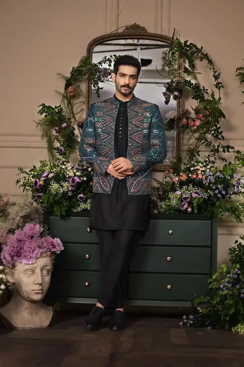 A man wearing a teal and gold embroidered jacket with intricate geometric patterns in fakhar-e-jahan collection