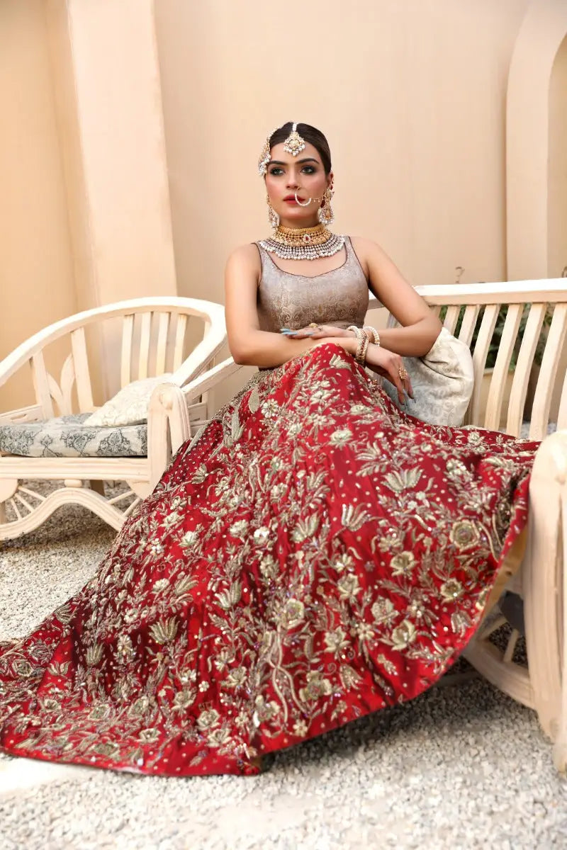 Malika red lehenga with antique gold tilla embroidery and floral patterns featuring a fitted bodice and flowing skirt