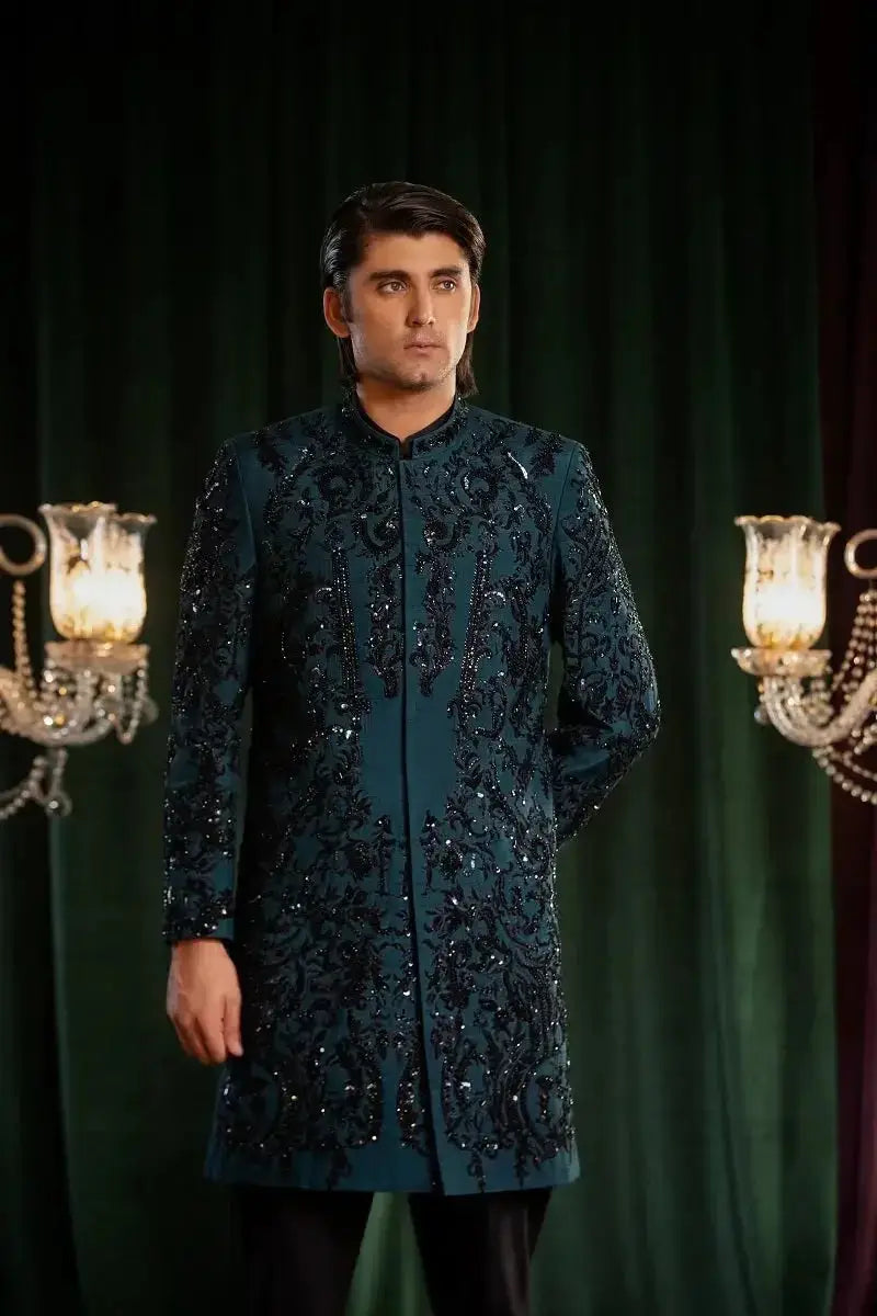 A dark teal embroidered sherwani with intricate black sequin and beadwork patterns from Mayameen