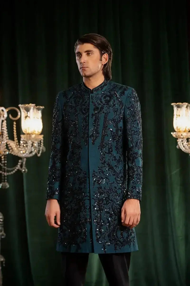 Dark teal embroidered sherwani with intricate black sequin and threadwork detailing from mayameen