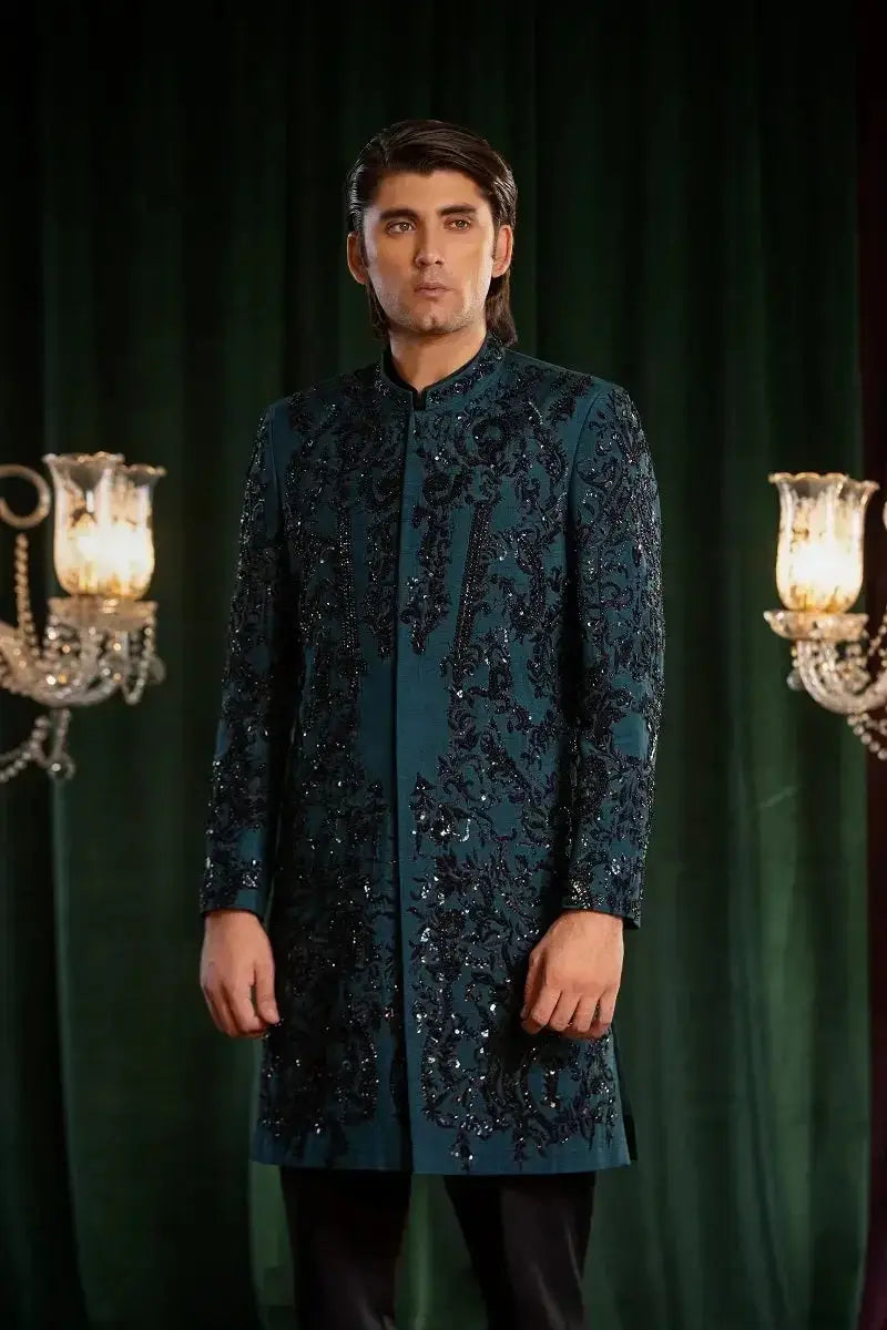 A dark teal long-sleeved sherwani named Mayameen with intricate black embroidery and sparkling sequins