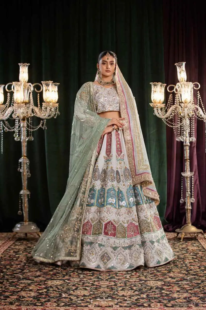 A woman wears the mehr-un-nisa ensemble lehenga in soft powder blue with gold embroidery for a high-fashion aesthetic