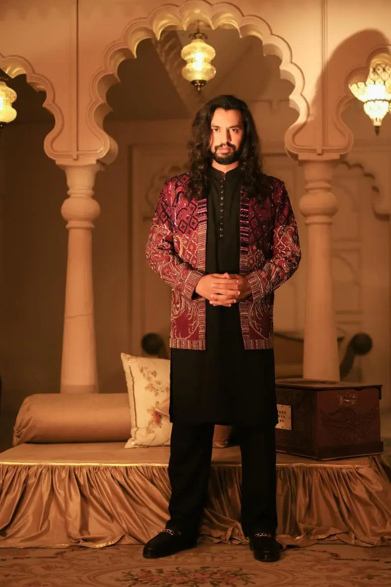 Mirza maroon and gold embroidered jacket with intricate paisley design over black traditional outfit