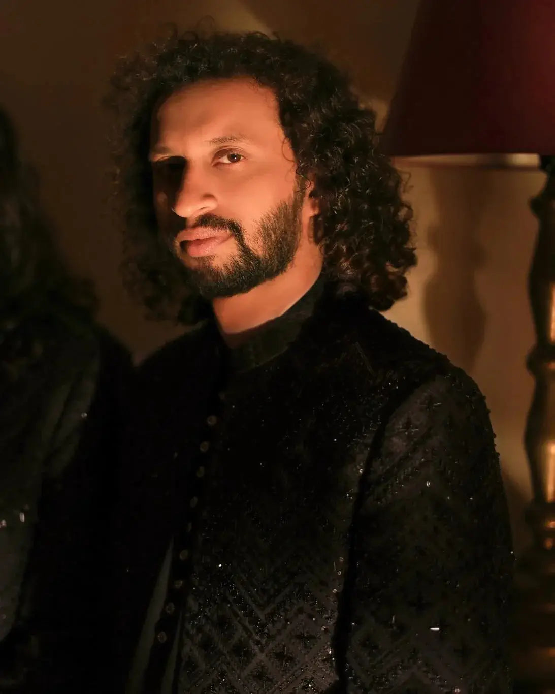 Black velvet nawab jacket with intricate silver embroidery and high collar for formal wear