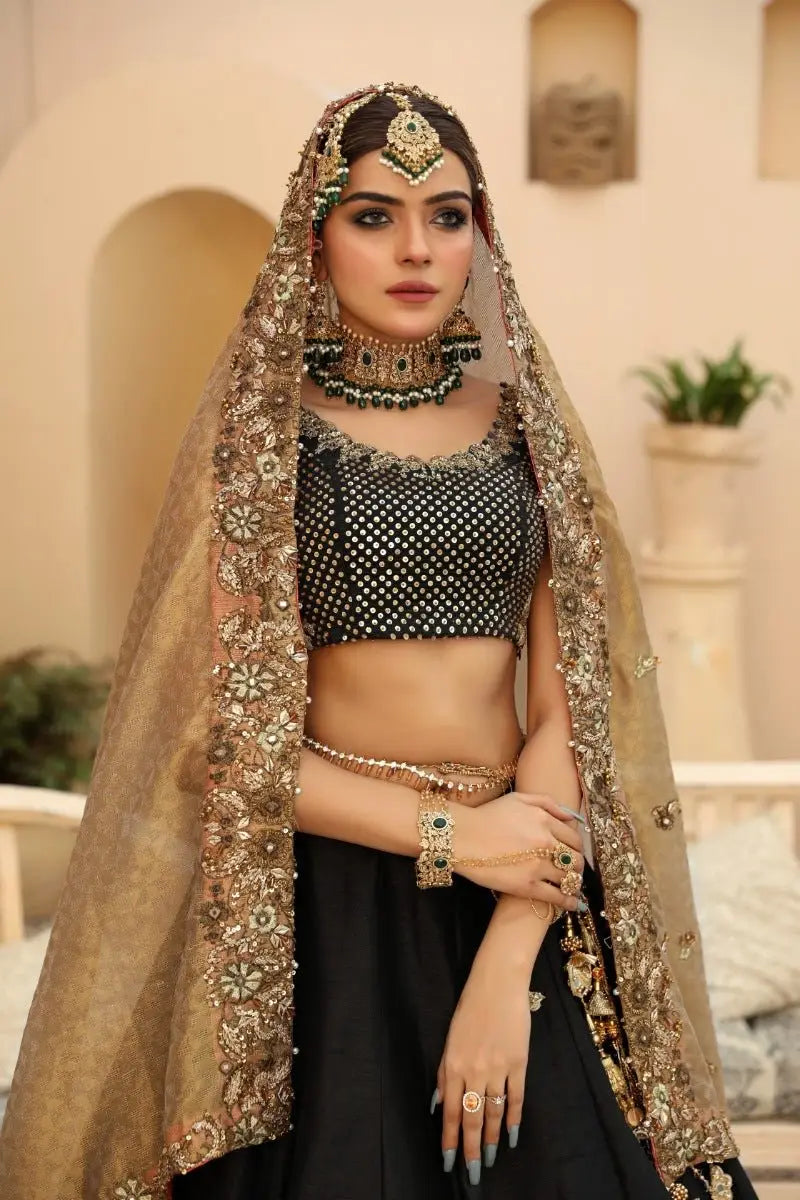 Nayab black and gold embroidered lehenga set with intricate floral detailing by ahsan tariq prince coat design