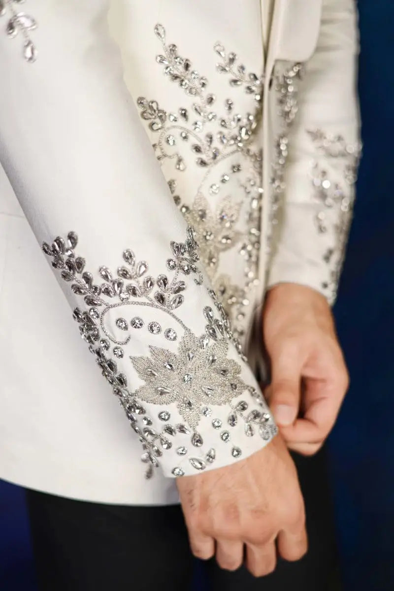 White satin jacket sleeve from notte di lusso adorned with intricate silver beading and crystal floral embellishments