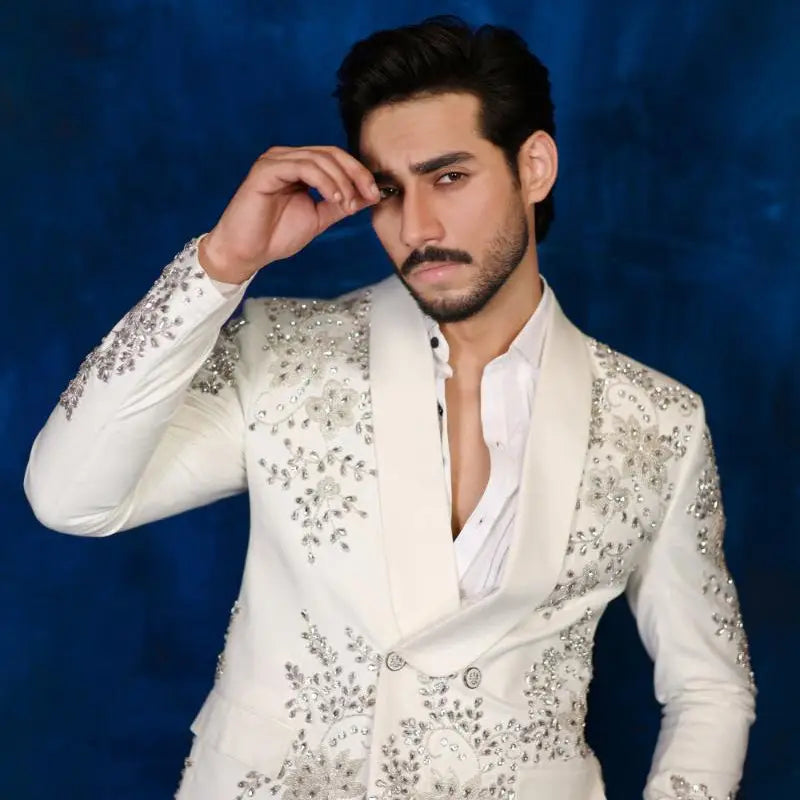A dazzling white tuxedo jacket with intricate silver beading and floral embroidery from notte di lusso ishq eidt 26