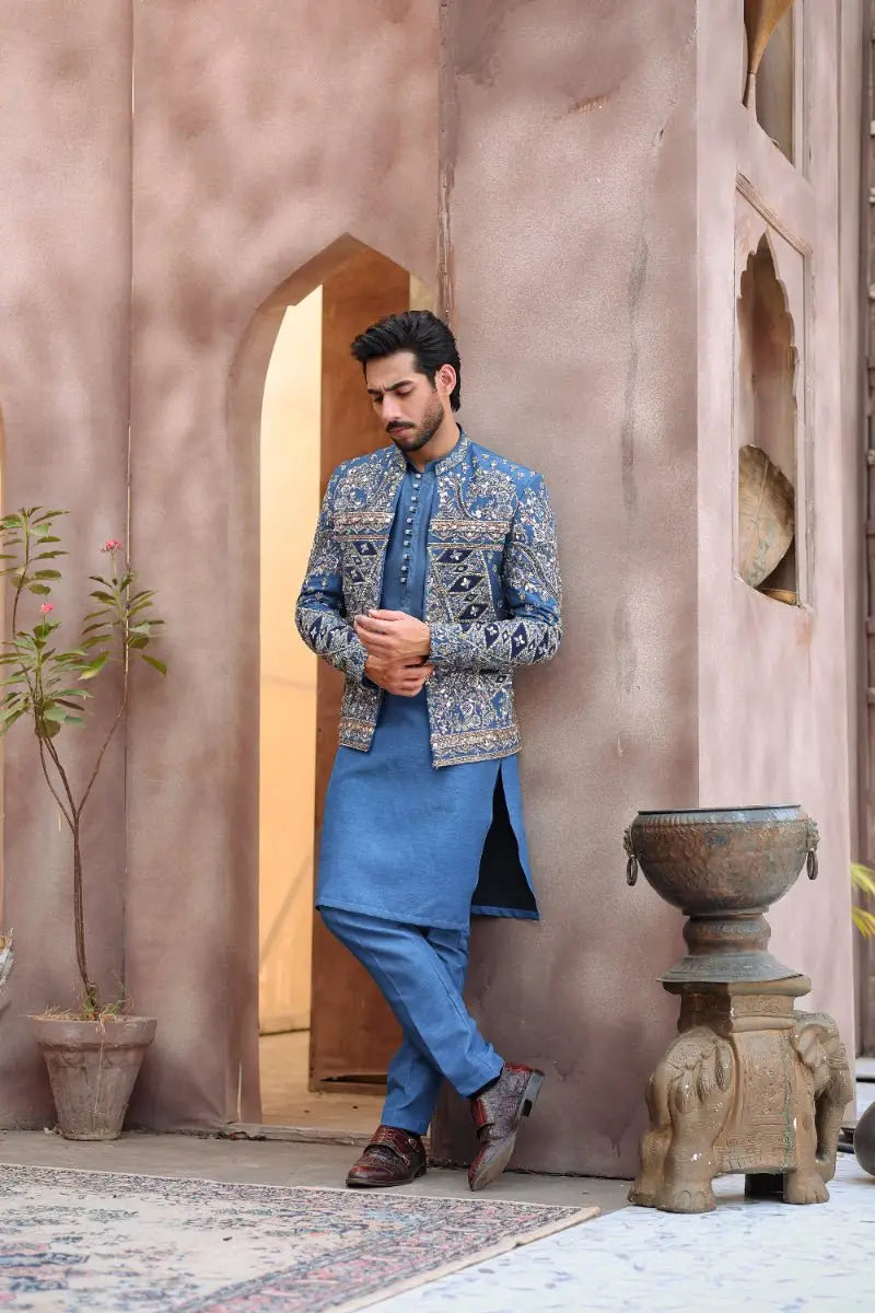 Blue embroidered men’s sherwani jacket with intricate silver threadwork and mandarin collar from ahsan tariq’s ishq collection