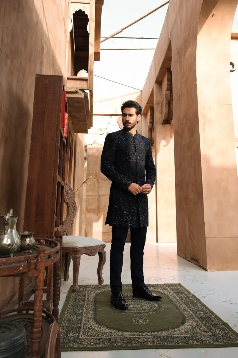 Black embroidered sherwani with intricate gold detailing from ahsan tariq ishq collection titled QARA