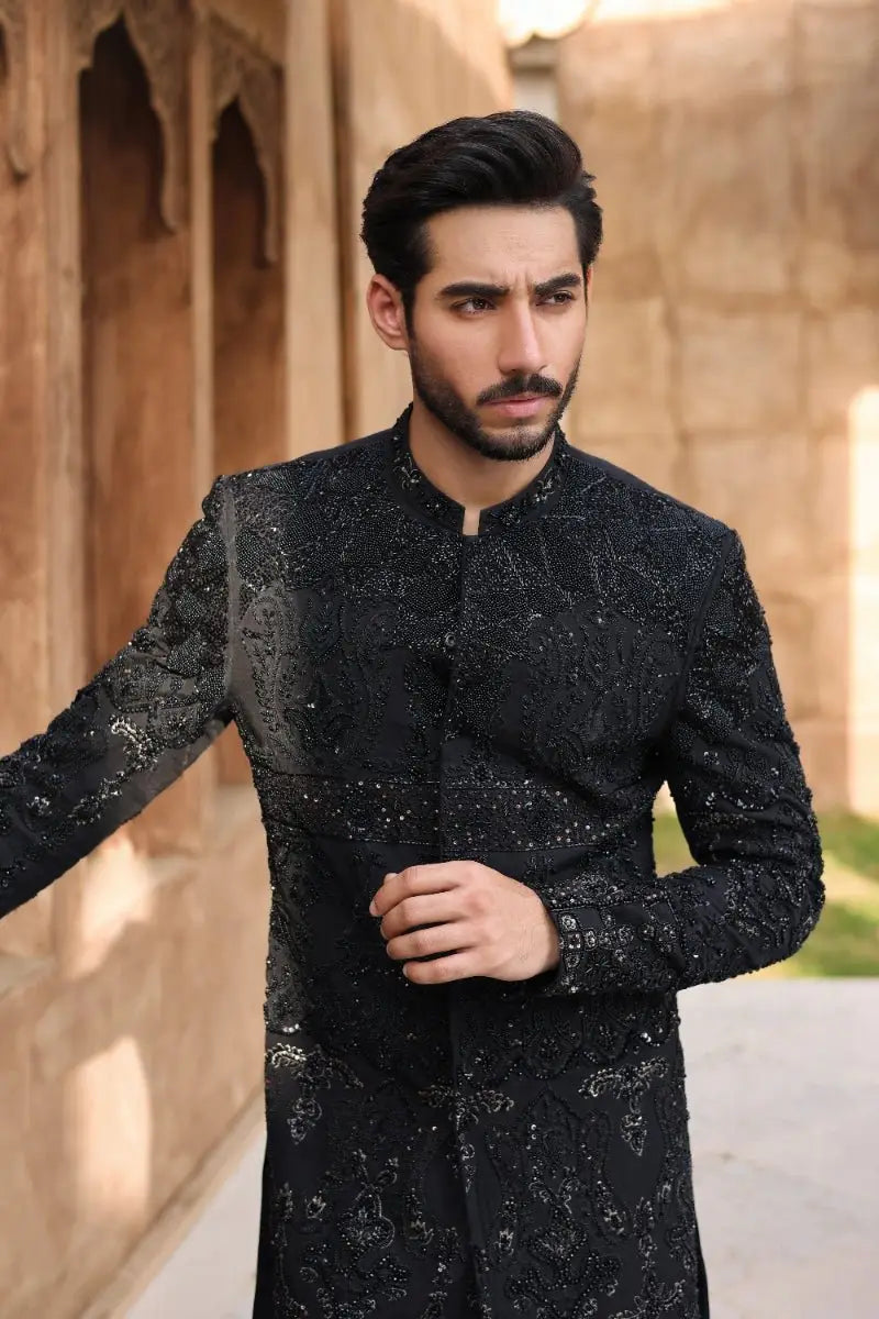 Black embroidered sherwani qara with intricate silver thread detailing from ahsan tariq ishq collection