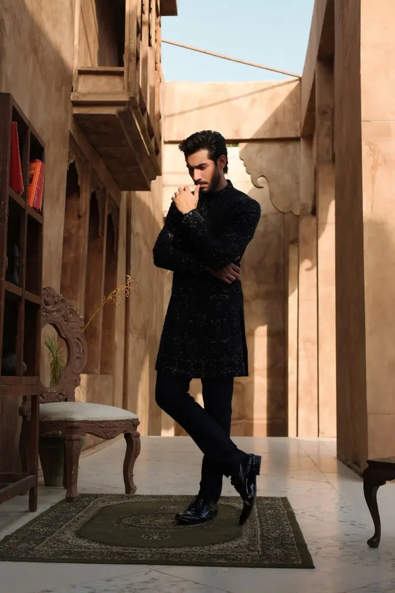Black sequined kurta with long sleeves and high collar paired with black trousers from ahsan tariq ishq collection