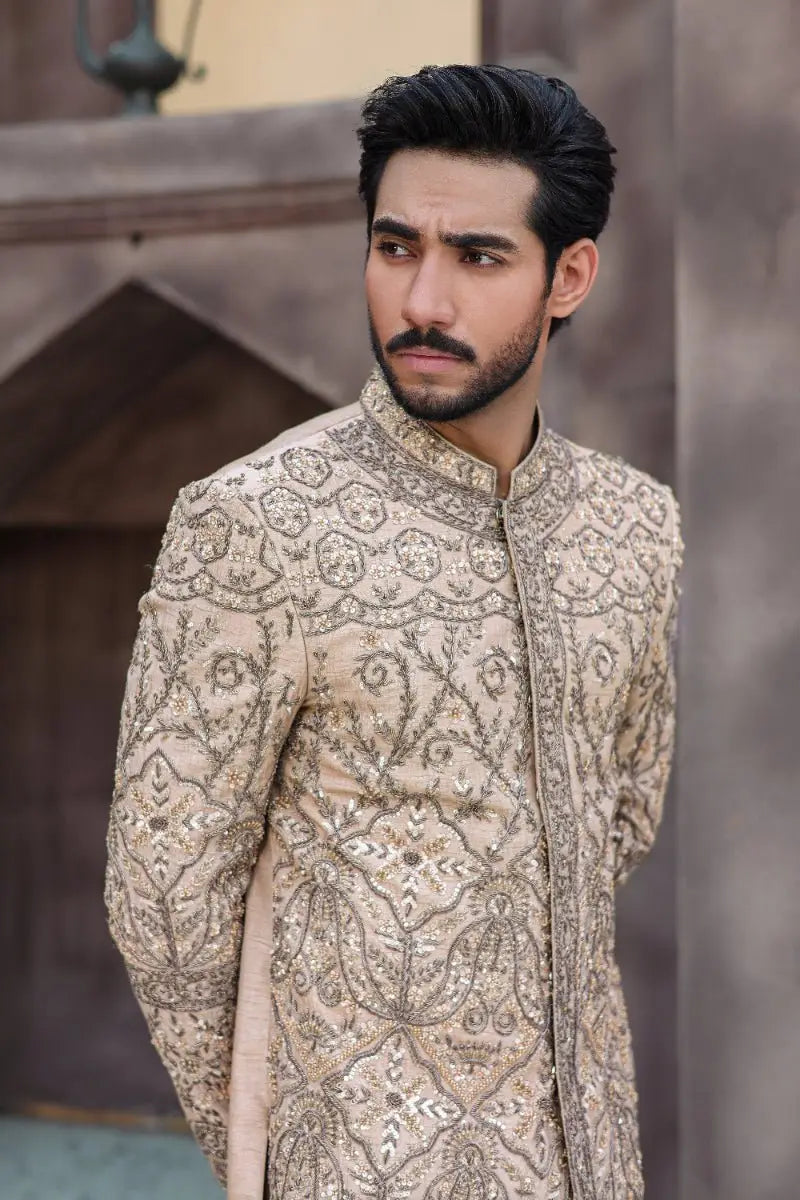 Beige embroidered sherwani qurb with intricate gold thread detailing from ahsan tariqs ishq collection