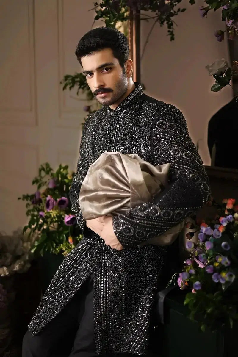 Black embellished sherwani with intricate silver beadwork and gold satin turban in ranjeet singh royal design