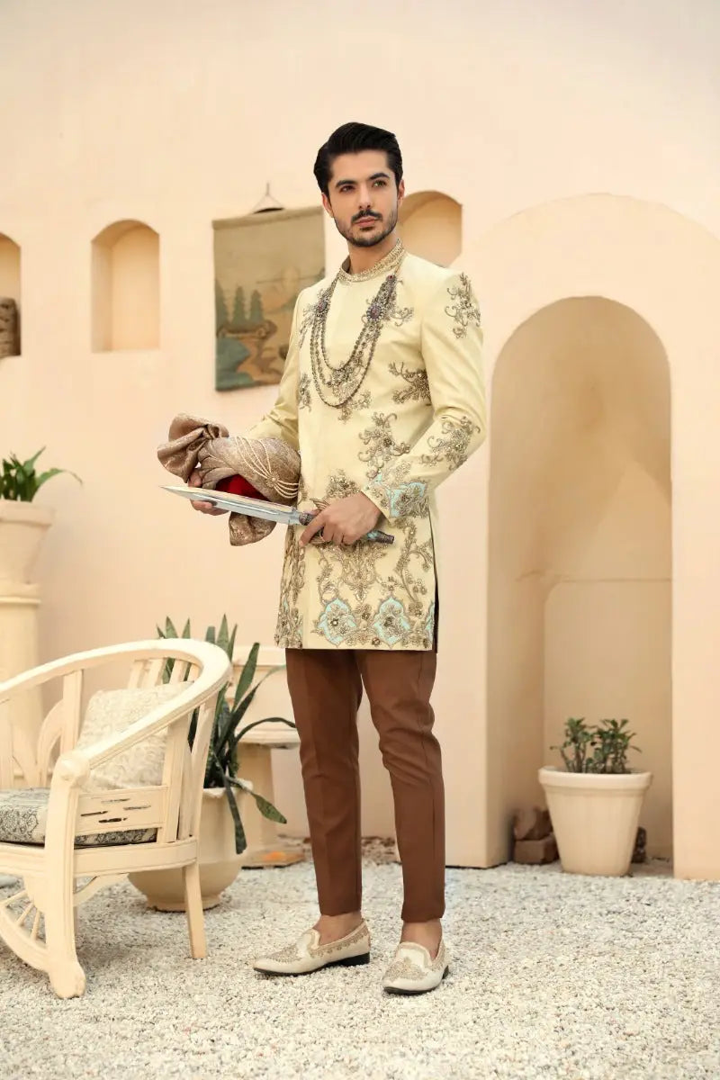 Beige embroidered sherwani sahar with antique gold and teal floral detailing from raqeeb se collection prince coat