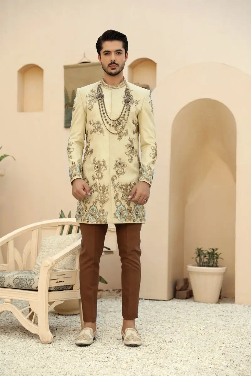 Cream-colored embroidered sherwani sahar with intricate antique gold and silver threadwork from raqeeb se collection prince coat