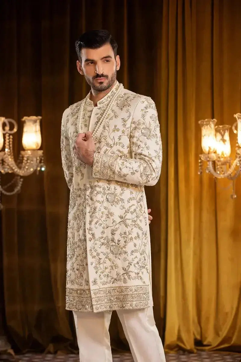 Beige SALEEM sherwani with intricate silver thread floral embroidery and a sequined hem for formal occasions