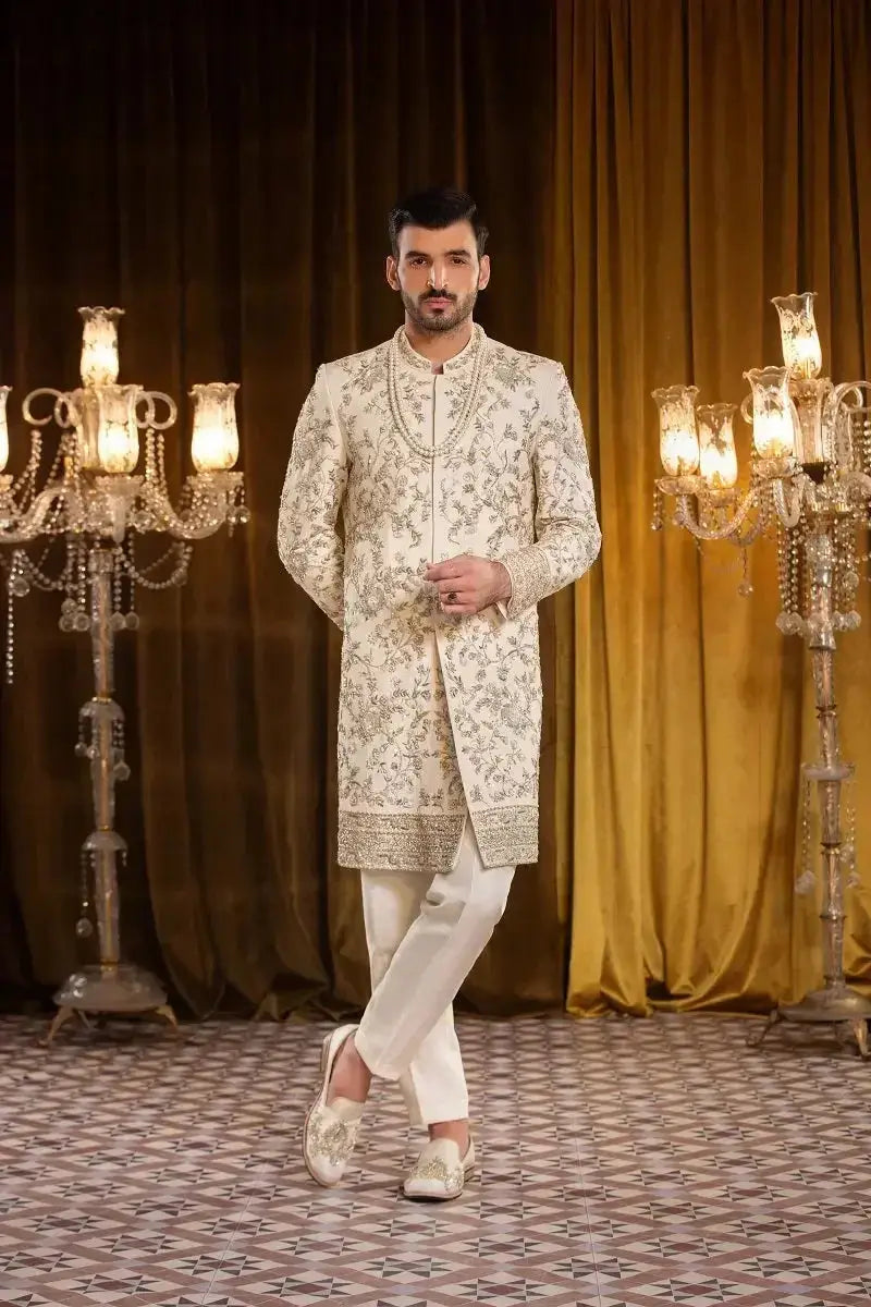 A cream-colored sherwani named SALEEM with intricate gold thread embroidery and a matching embellished collar