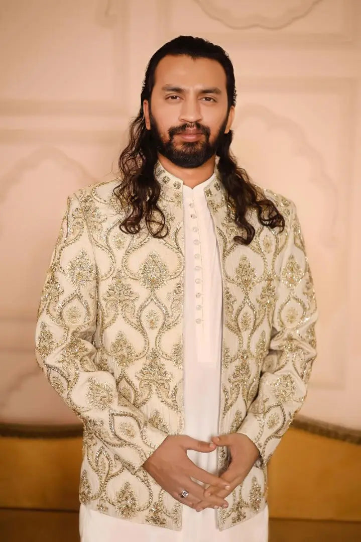 Sikandar cream-colored intricately embroidered jacket with gold thread detailing and a high collar
