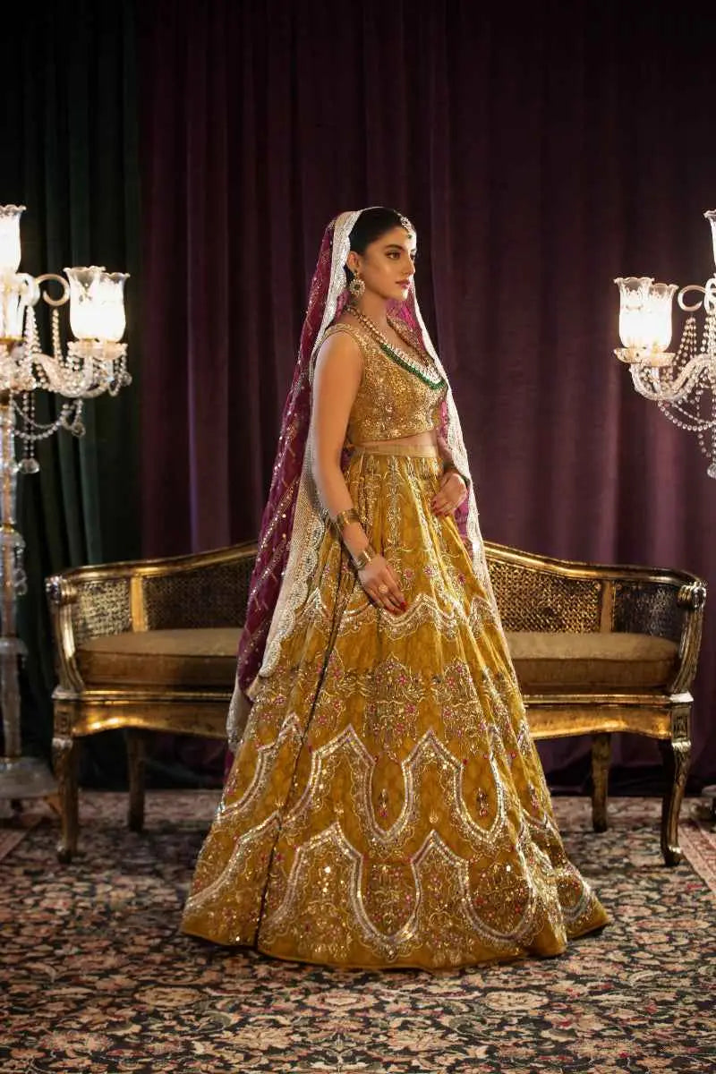 Sila golden lehenga features architectural chevron silver embroidery with a matching crop top and maroon white dupatta