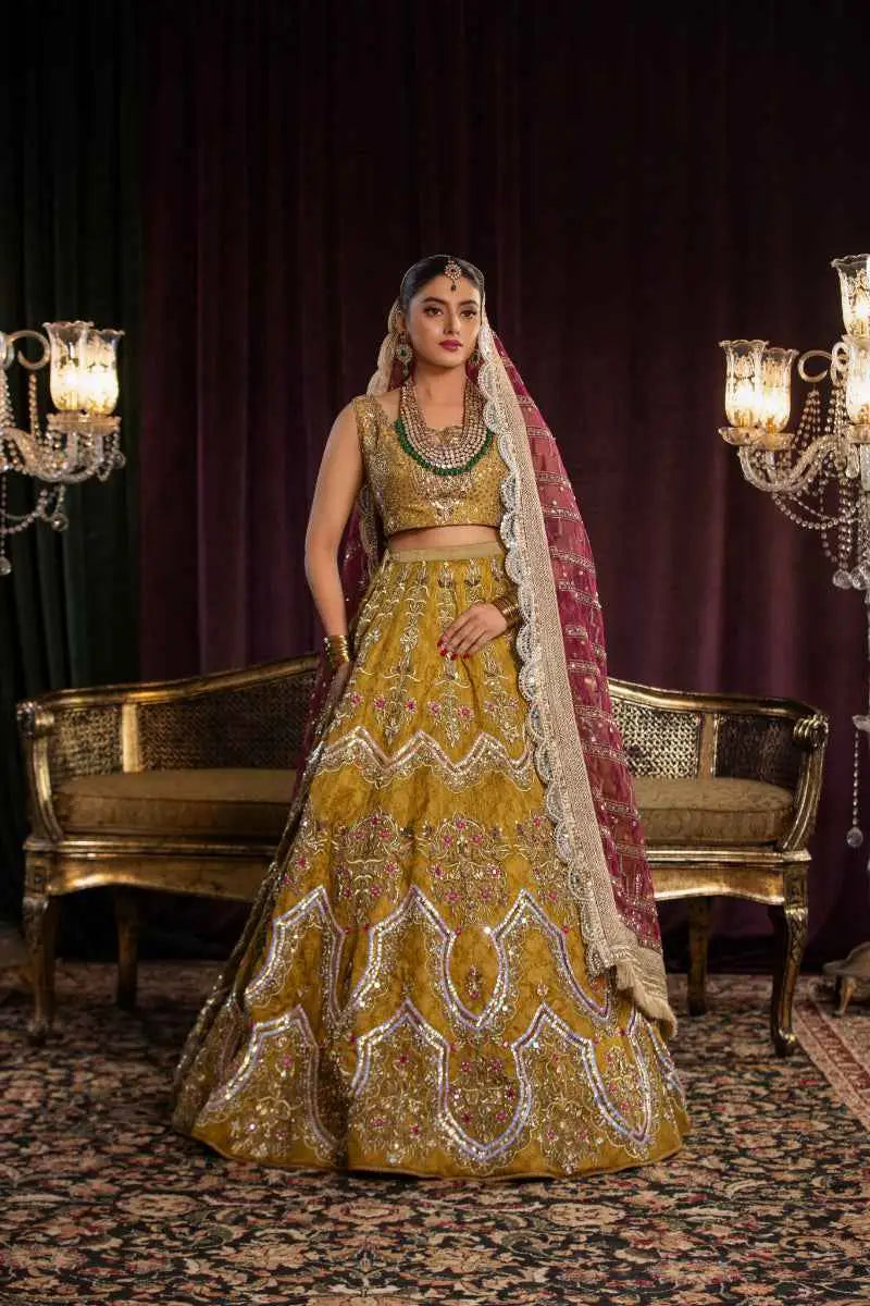 Sila golden lehenga features architectural chevron silver embroidery paired with a matching maroon dupatta geometric patterns intricately