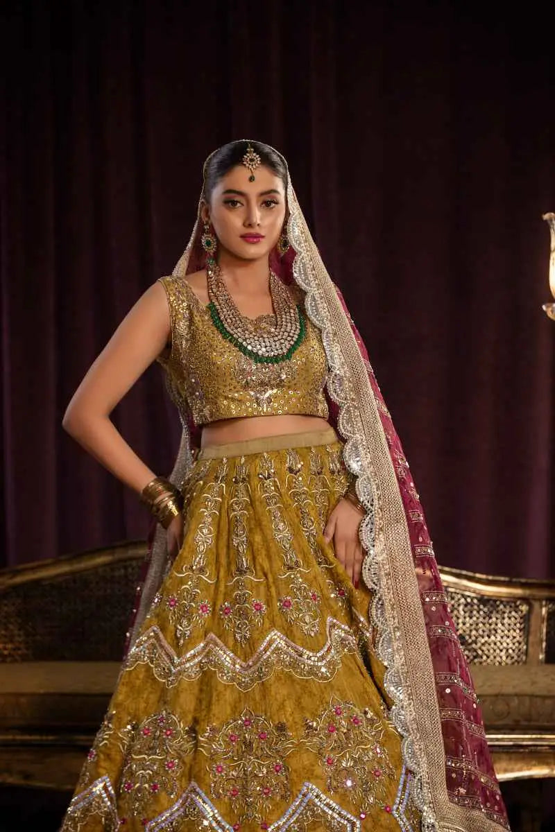 Sila lehenga features architectural chevron patterns in gold with intricate silver and pink embroidery and a matching crop top