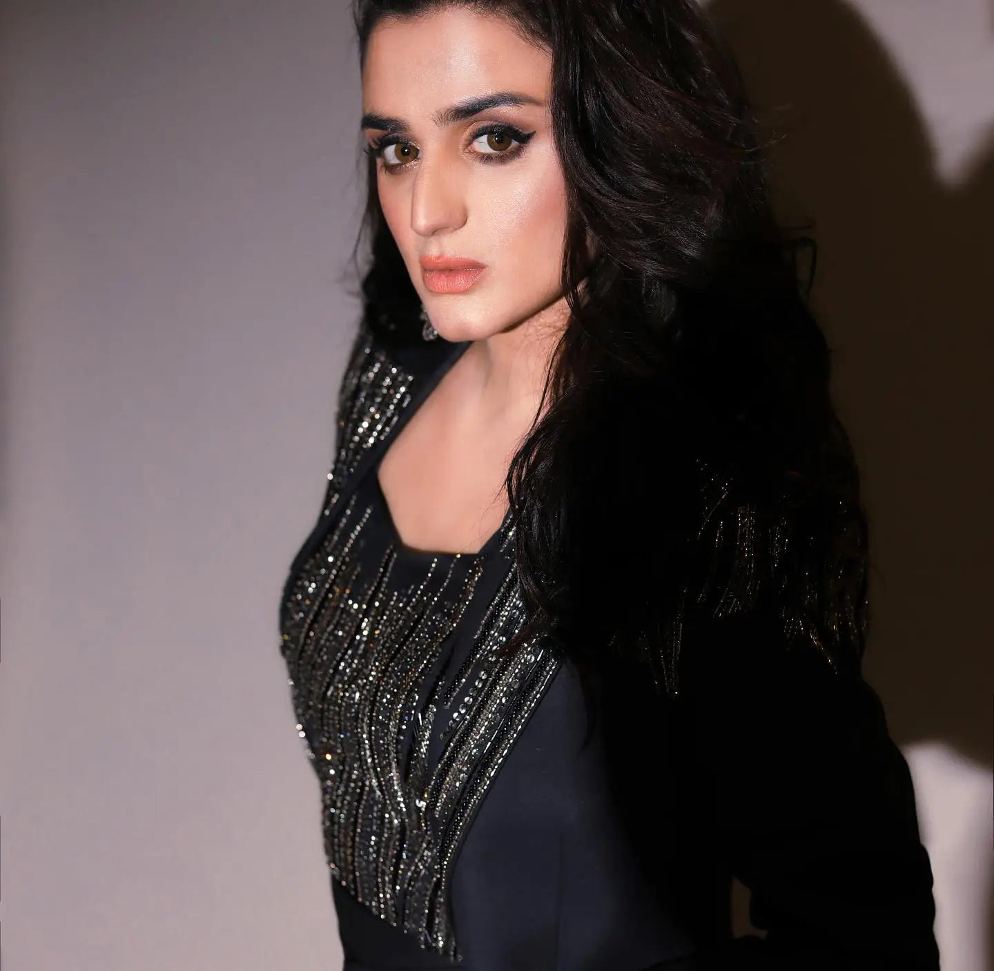 A black sequined top with shimmering vertical stripes defining modern luxury for avant-garde three-piece power looks