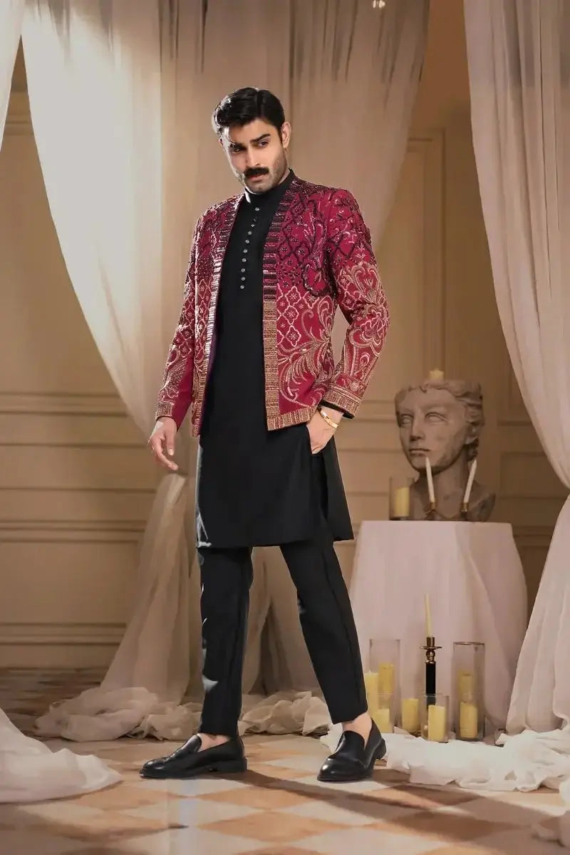 Thakur Singh richly embroidered red and gold patterned jacket with intricate detailing worn over black traditional outfit
