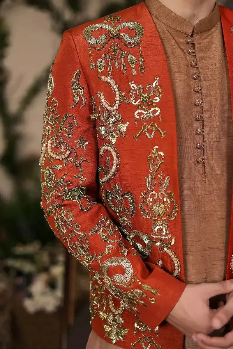 Vibrant orange silk wazir khan jacket with intricate gold and silver floral and bow embroidery front view