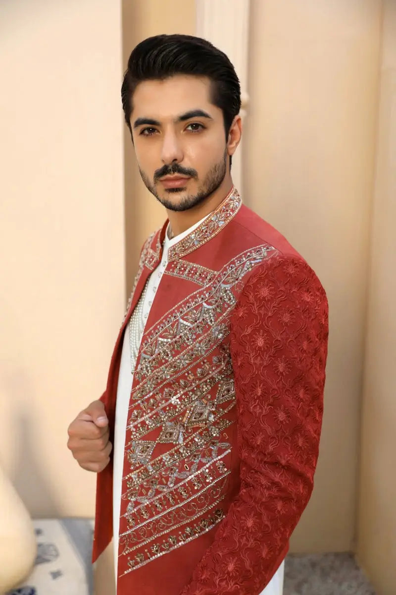 Red embroidered sherwani with intricate silver threadwork and floral motifs by ahsan tariq from yaqoot collection